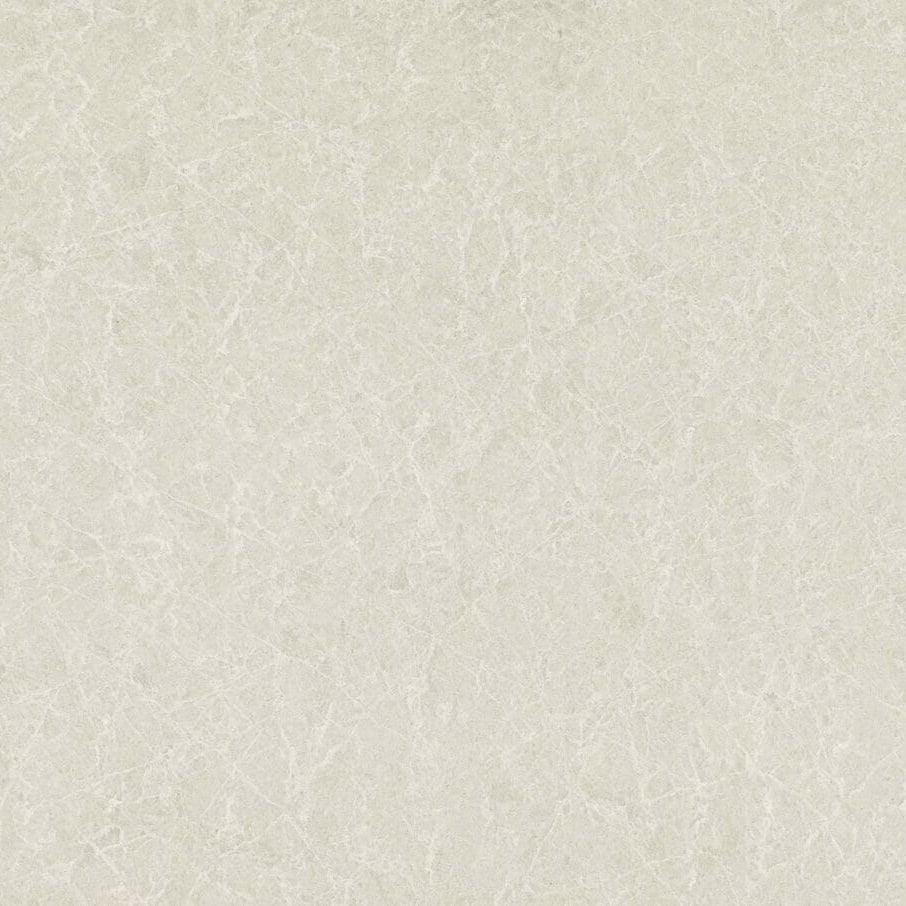5130 Cosmopolitan White surface featuring delicate cream tones with elegant ashen streaks and speckles.