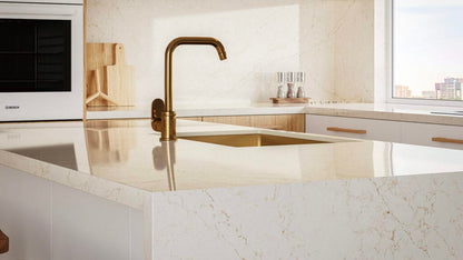 Modern kitchen featuring 5144 Rossa Nova countertop with golden accents and crisscrossed veining, showcasing elegant design.