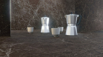 Beautiful kitchen scene with espresso maker and ceramic cups on a dark marble countertop featuring rich earthy tones.