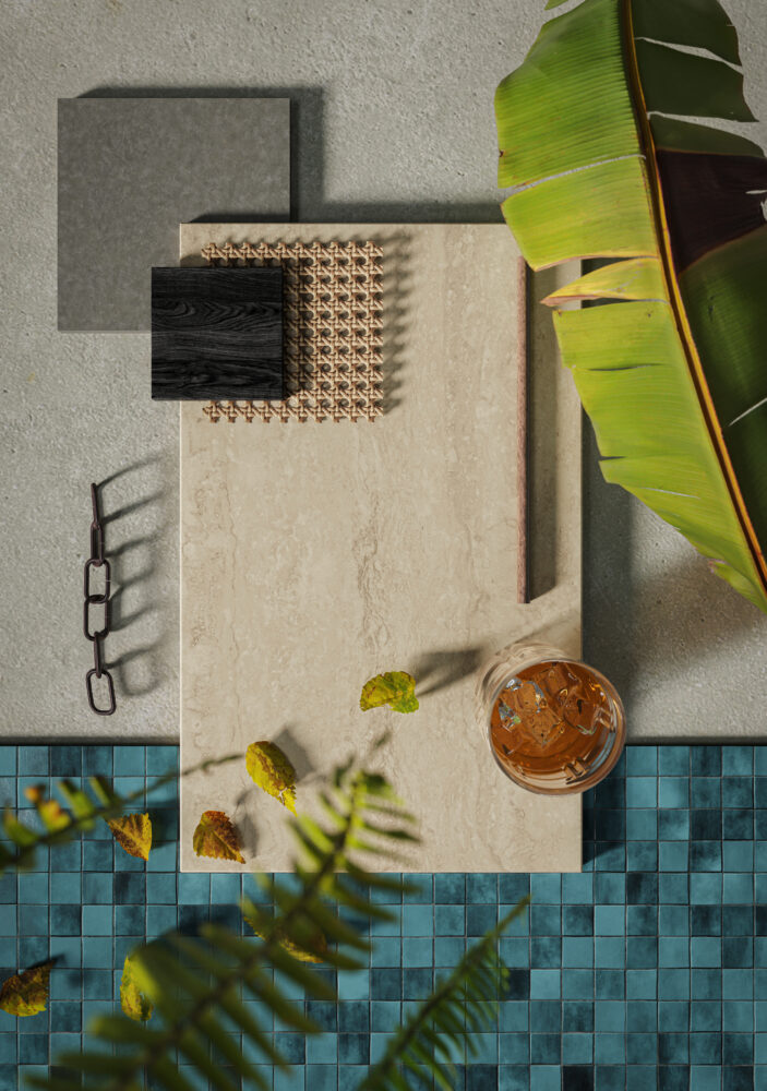 Stylish flat lay featuring 550 Silvax stone finish, grey tones, tropical leaves, and a glass of iced drink.