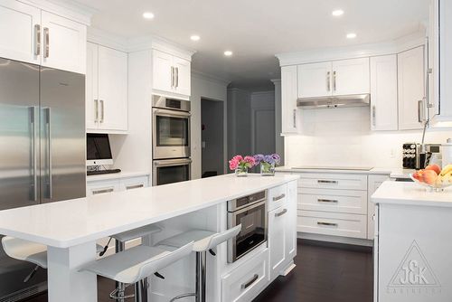 Modern kitchen featuring J&K White Shaker cabinets, elegant solid wood construction, and a stylish island design.