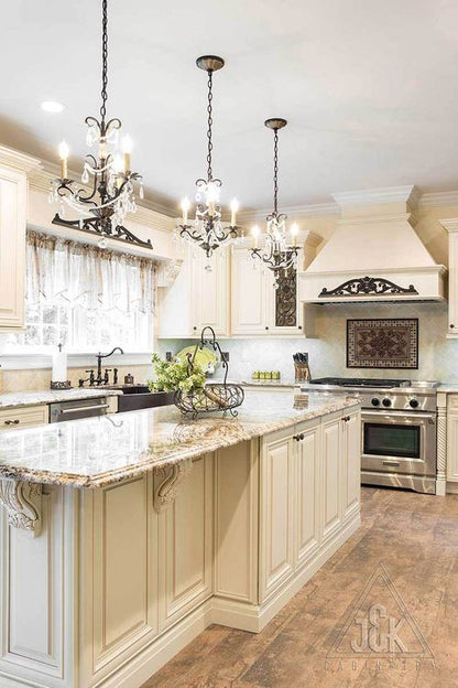 Elegant kitchen featuring J&K’s Creme Glazed cabinets, solid wood construction, and stunning granite countertops.