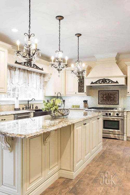 Elegant kitchen featuring J&K’s Creme Glazed cabinets, solid wood construction, and stunning granite countertops.