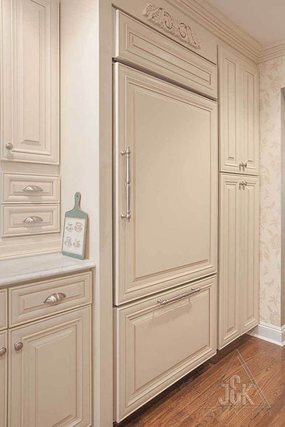 Elegant cream glazed cabinetry and refrigerator, showcasing superior construction with 100% solid wood by J&K.
