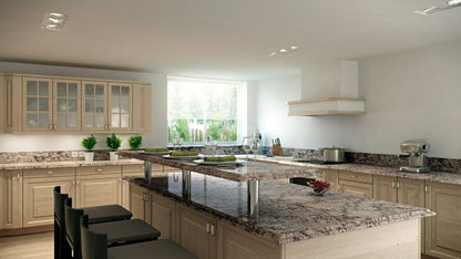 Modern kitchen with light wood cabinets and a granite countertop featuring dramatic grey veining and ample natural light.