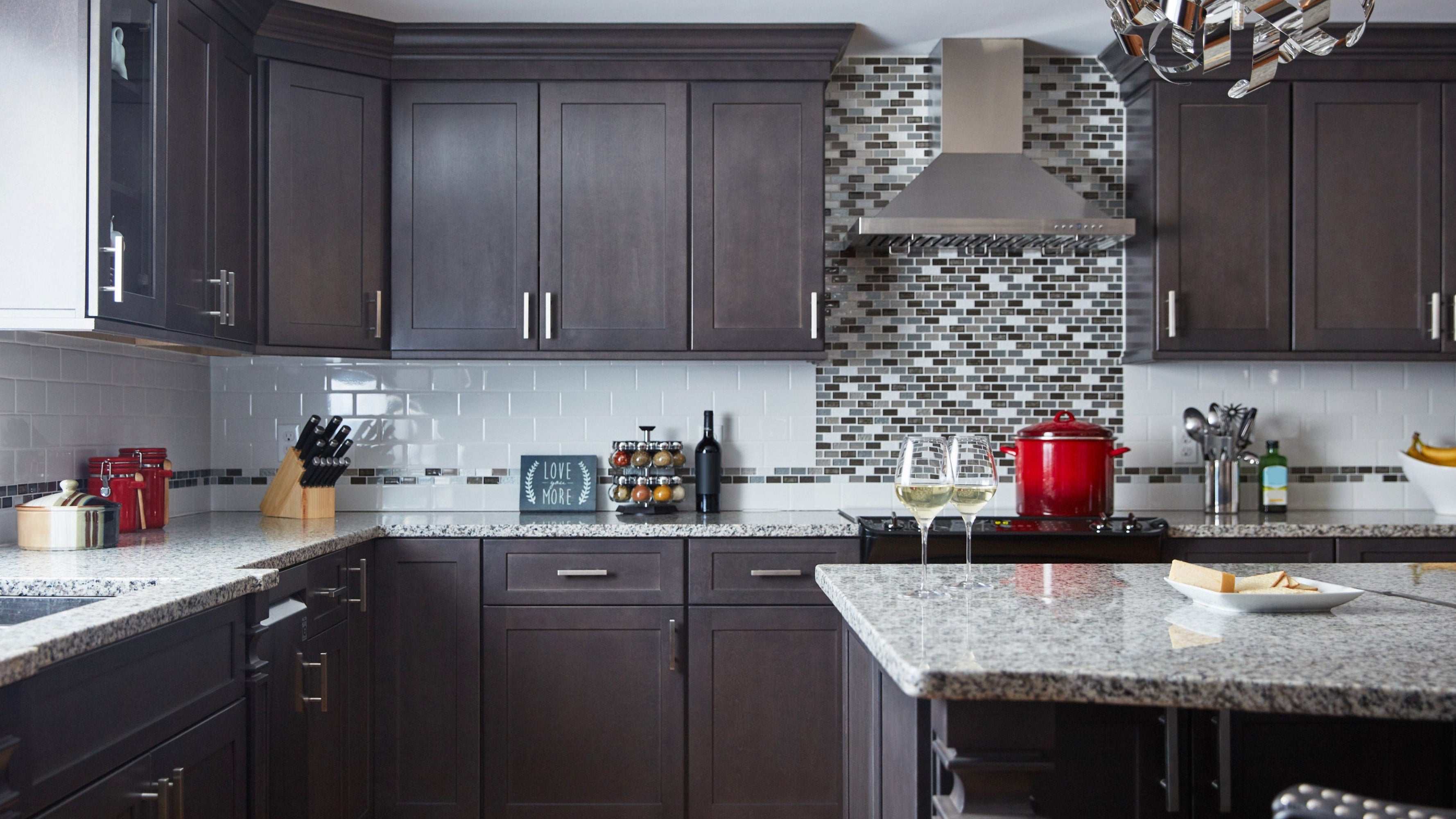 Modern kitchen featuring Allure Galaxy Cobblestone cabinets with elegant granite countertops and stylish backsplash.