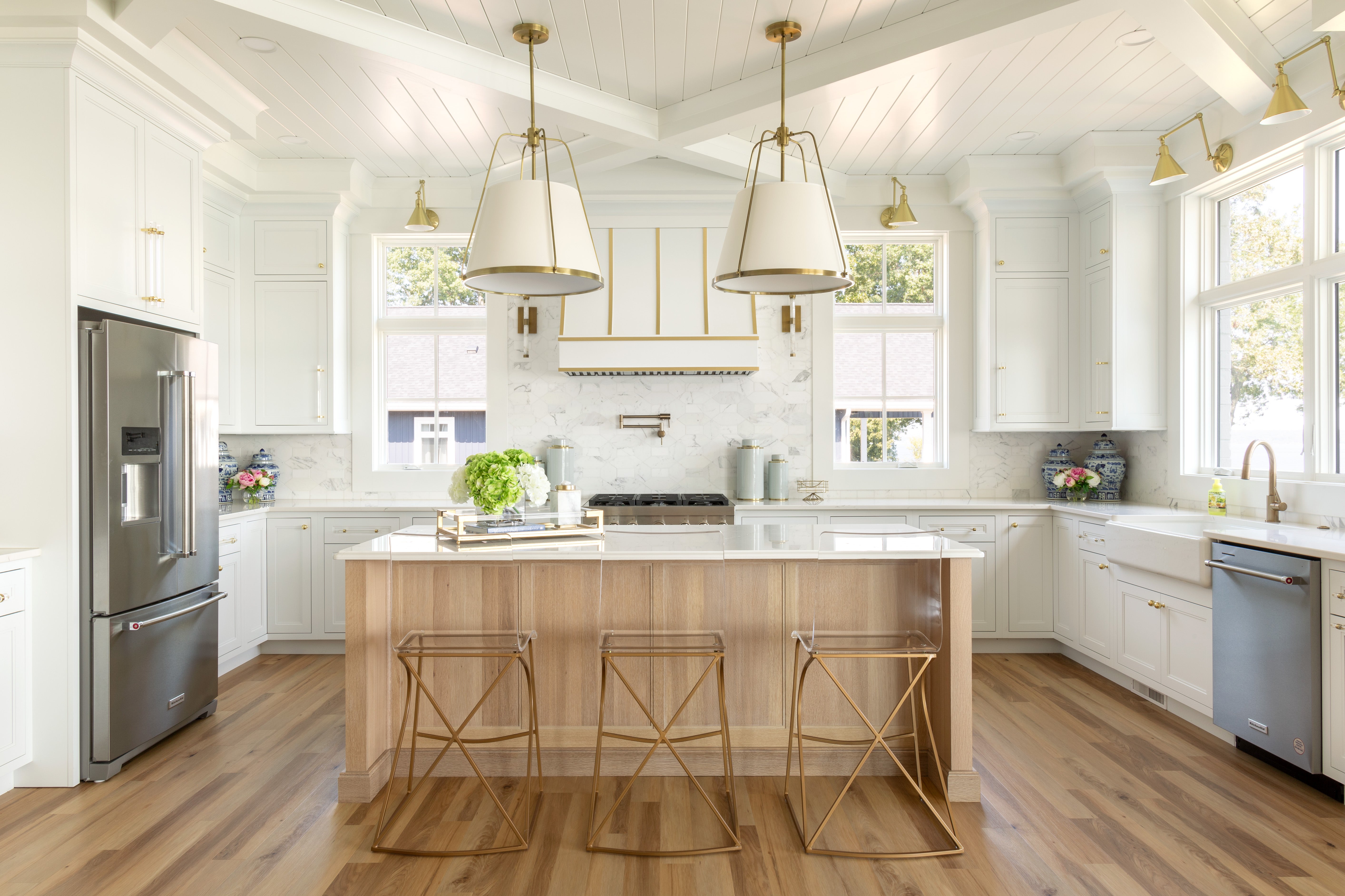 Modern kitchen featuring Shiloh cabinets, wooden island, and stylish pendant lights, ideal for custom cabinetry design.