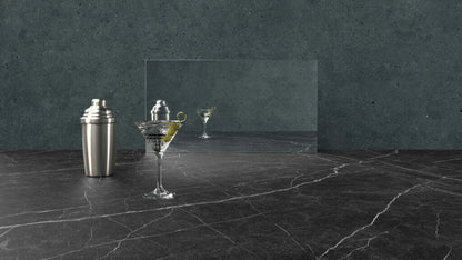 511 Smokestone marble surface with shaker and martini glass, showcasing its midnight-black and chalky-white striking lines.