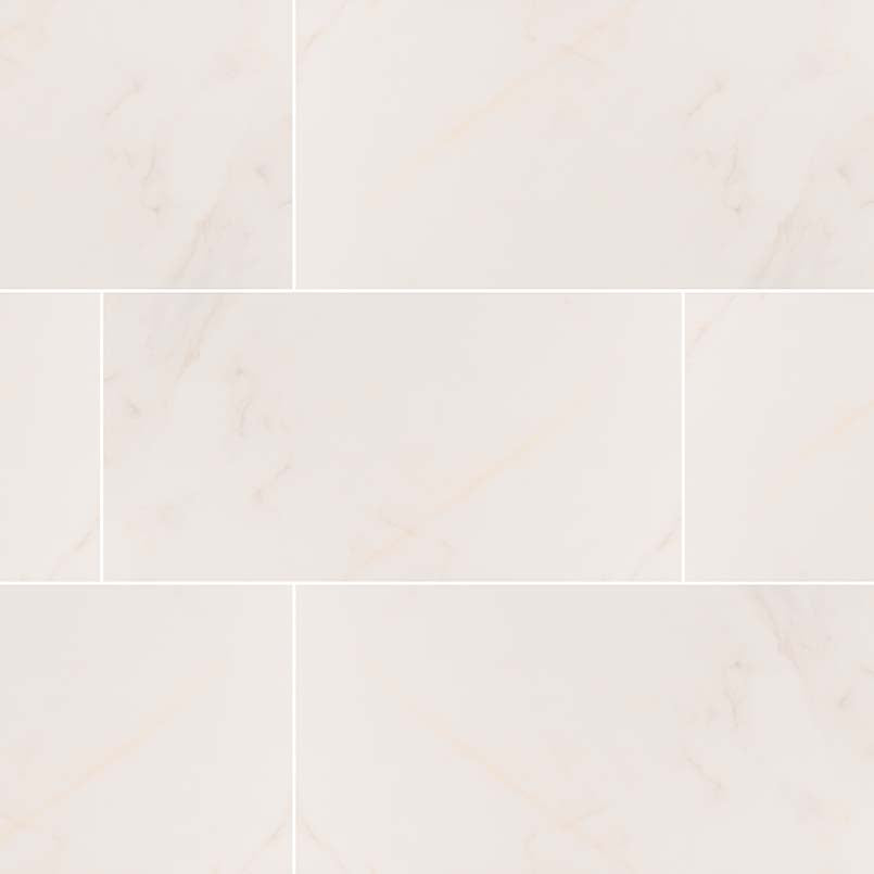 Adella Calacatta 12X24 satin ceramic tile with soft white background and gray marble veins.