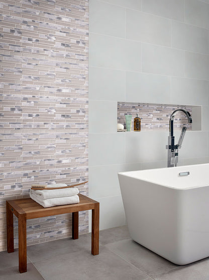 Modern bathroom featuring Adella White tiles, elegant soaking tub, and stylish wood bench for a chic, contemporary look.