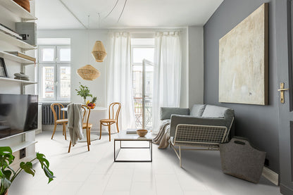 Modern living room featuring Adella White 12x24 satin ceramic tile, elegant decor, and natural light.