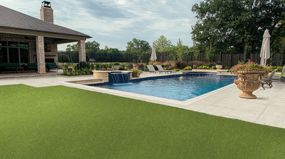 Elegant outdoor space with a pool, limestone pavers, and landscaped lawn for a serene ambiance.