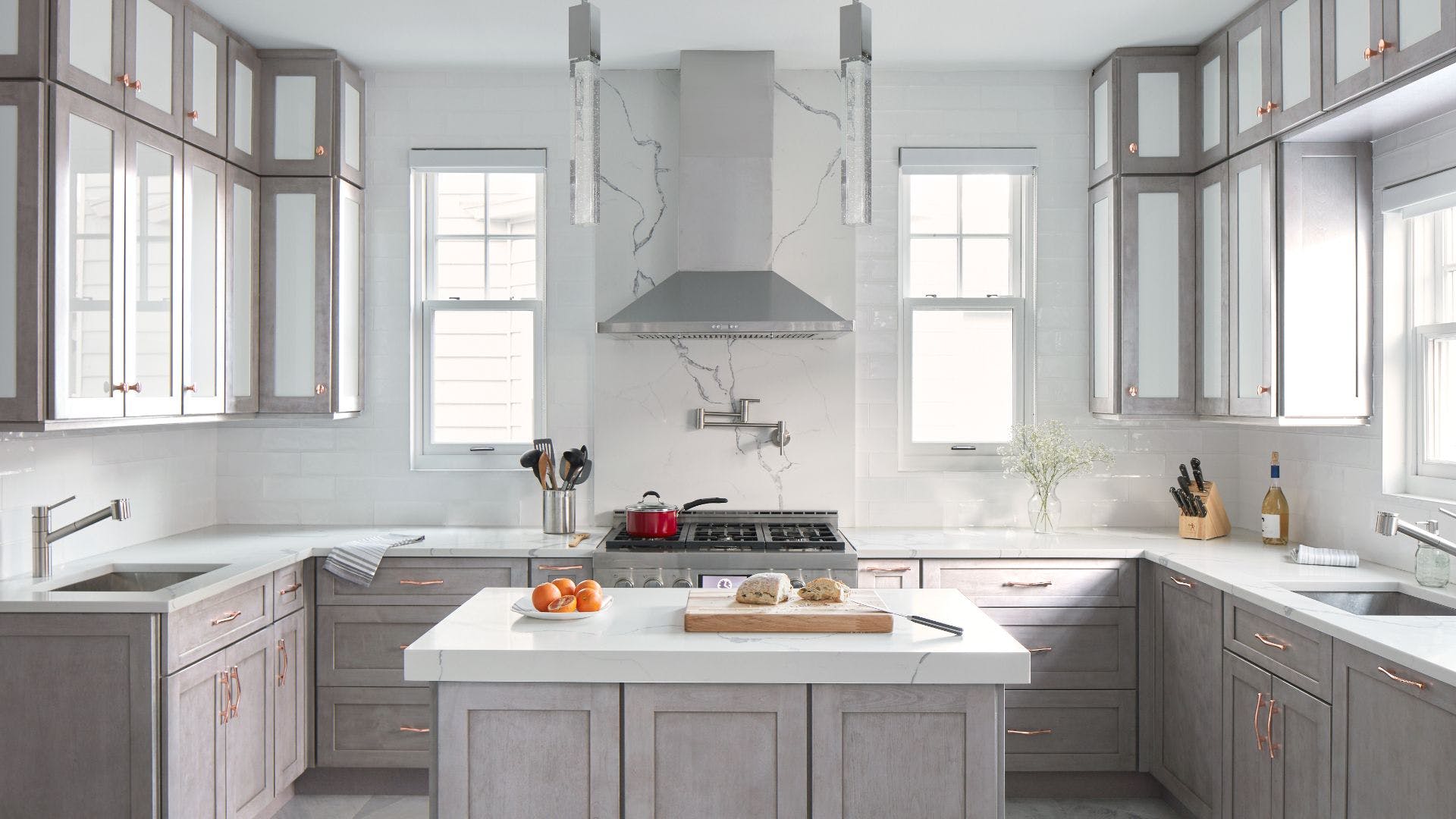 Contemporary kitchen featuring Allure Galaxy Horizon cabinets in grey with pink undertones and polished finishes.