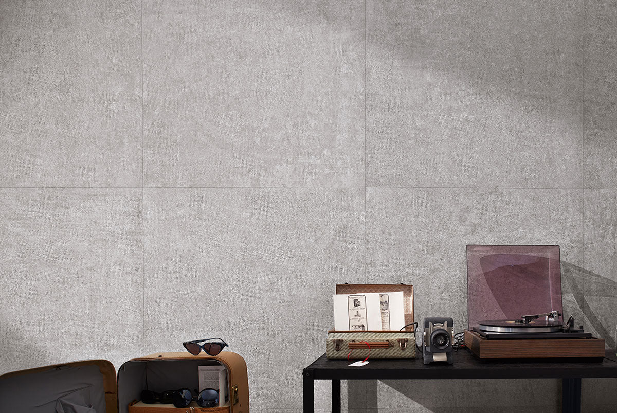Concerto Grigio porcelain tile highlighting a modern indoor space with a vintage record player and stylish decor.