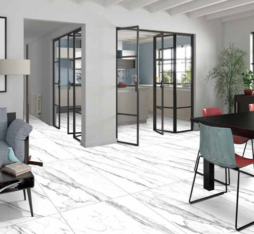 Lasa Bianco Tile - Rocker in a modern kitchen and dining area, showcasing elegant, marble-patterned flooring.