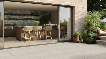 Livingstyle Pearl 18x36 Matte pavers enhance a modern outdoor kitchen with soft gray tones and natural stone look.